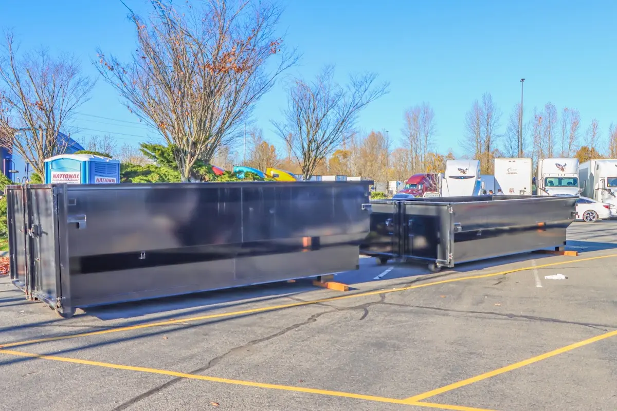 Professional dumpster rental service with roll-off container on residential driveway in Alum Rock